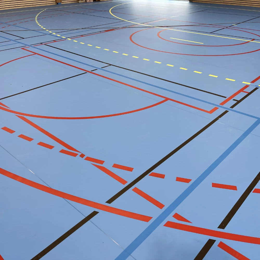 revêtement de sol de gymnase sportif pour lycée, sol bleu avec marquages sportifs